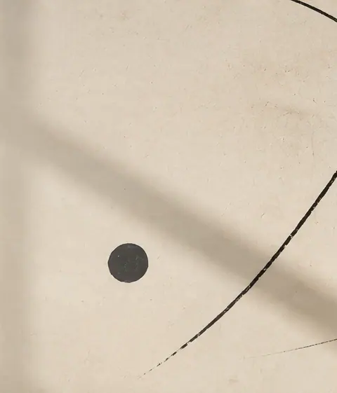 Abstract cream and black shapes crossed by a gold arc
